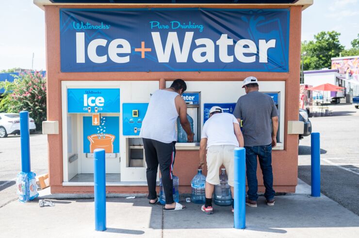 Residents fill up water jugs at a vending machine during a July heatwave in Austin, Texas.
